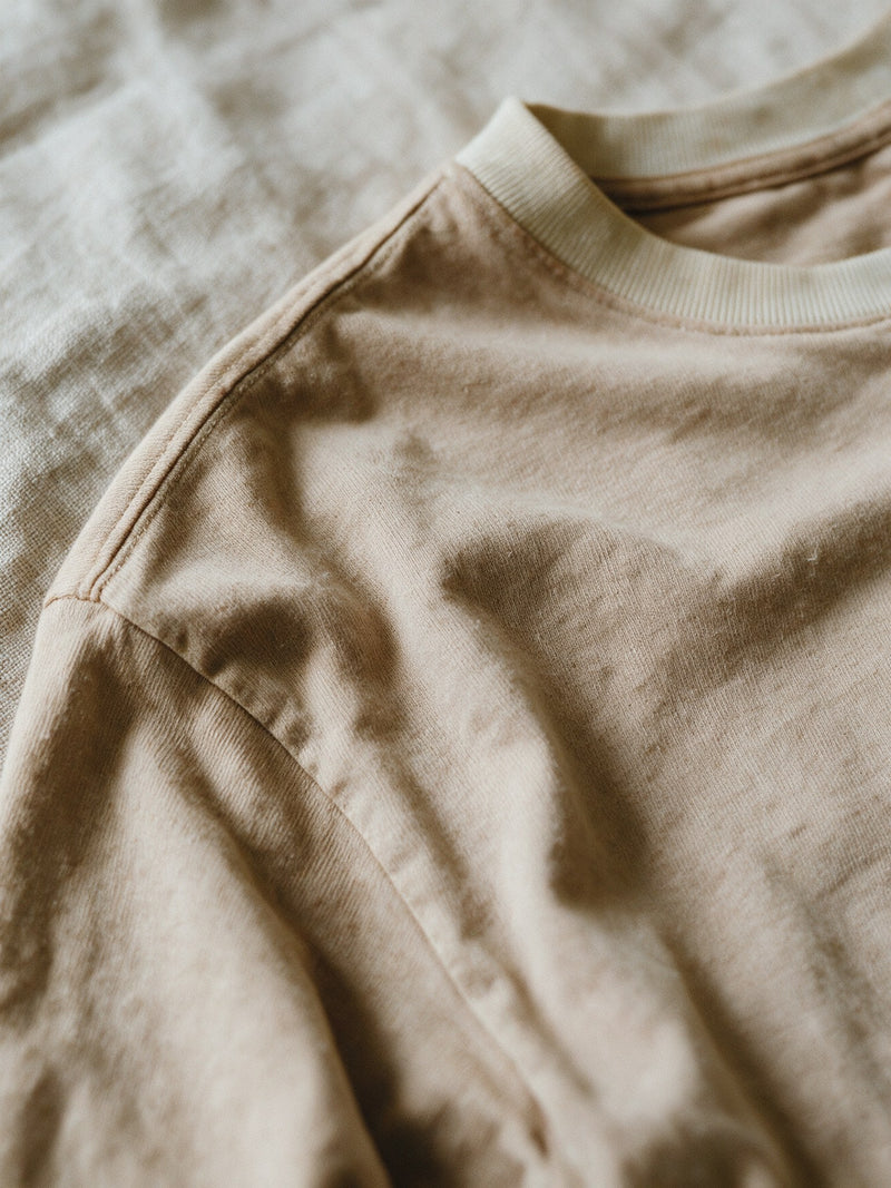 Egyptian cotton up close — the ribbed collar and shoulder seam of the HASK tee