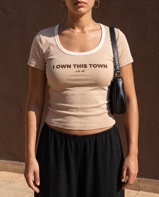 I Own This Town Tee in Sand — fit detail on model