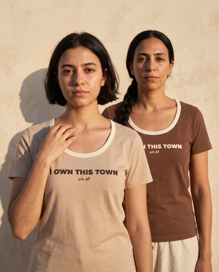 I Own This Town Tee in Sand — and in Umber — on two models