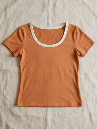 The Fitted Tee in Sunrise — laid flat on linen
